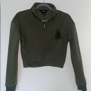 Small green justify sweater with cute dragon on the left side